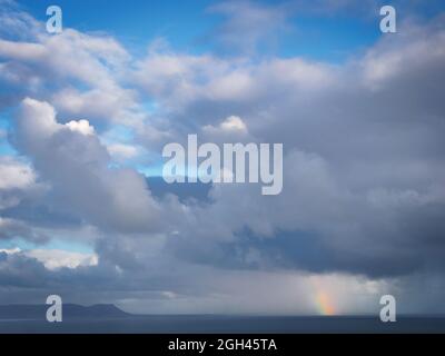 Rain squall, rainbow and storm at sea. Hermanus, Whale Coast, Overberg, Western Cape. South Africa Stock Photo