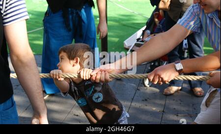 BARCELONA, SPAIN - Sep 24, 2010: People playing tug of war outdoors in Barcelona, Spain during the local La Merce holiday Stock Photo