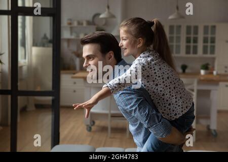 Happy dad and excited daughter having fun, enjoying home activities Stock Photo