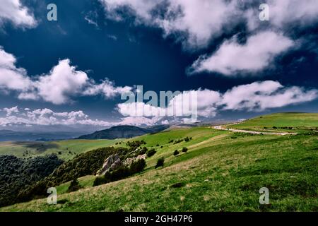 panorama of the beautiful countryside. sunny afternoon. beautiful spring landscape in the mountains. grassy field and hills. rural landscapes