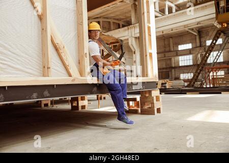 Handsome man builder using modern laptop at work Stock Photo