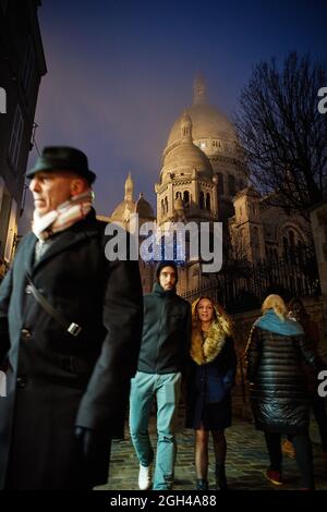 Paris, France - December 2016:  passers-by walking around Montmartre's Basilica of the Sacré Cœur. Stock Photo