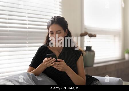 Serious thoughtful mobile phone user reading text message on screen Stock Photo