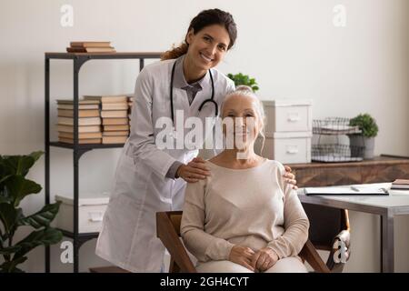 Portrait of happy senior lady visiting doctor, looking at camera Stock Photo
