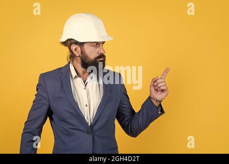 mature bearded man or businessman in costume and helmet, architechture Stock Photo
