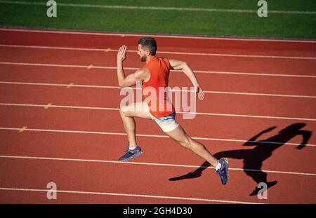 Energy inside. runner on racetrack. challenge and competition. marathon ...