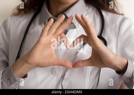 Female doctor making hand and finger heart shape Stock Photo