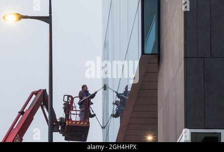 Cork City, Cork, Ireland. 05th September, 2021. Robert Healey and Cormac Higgins cleaning the windows using a telescopic boom on the offices at One Albert Quay on a damp misty morning in Cork City, Cork, Ireland.  - Picture; David Creedon Stock Photo