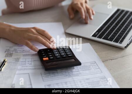 Close up smart young woman calculating domestic utility bills. Stock Photo