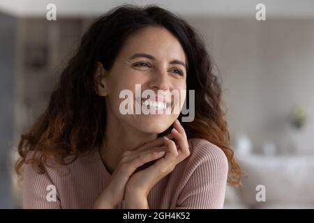 Joyful attractive young latin woman daydreaming, looking in distance. Stock Photo
