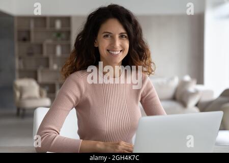 Portrait of smiling attractive millennial confident hispanic woman. Stock Photo