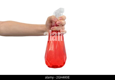 Female hand holding red spray bottle isolated on a white background photo Stock Photo