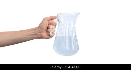 Transparent jar of water, carafe glass in hand isolated on a white background photo Stock Photo