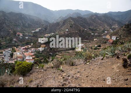 Vallehermoso is the main settlement of the Hermoso valley in a steep canyon where the Barranco del Valle enters at the north coast of La Gomera Stock Photo