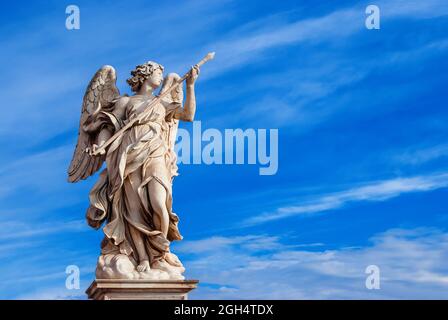 Angel holding the Holy Lance of Longinus with beautiful sky. A 17th century baroque masterpiece at the top of Sant'Angelo Bridge in the center of Rome Stock Photo