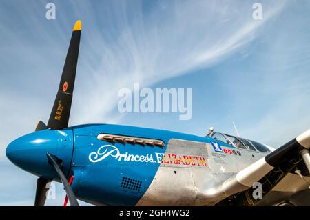 North American P-51 Mustang fighter plane named Princess Elizabeth. Blue nosed Second World War US fighter plane in blue sky with wispy clouds Stock Photo