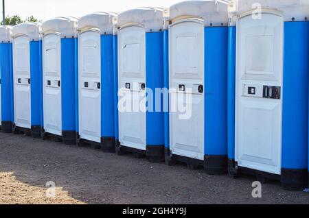 Row of portable toilets at an outdoor event