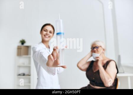 emotional elderly woman hand injection fun Stock Photo