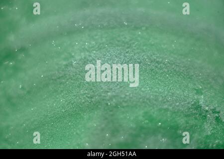 frig snow on green bottle with selective focus Stock Photo