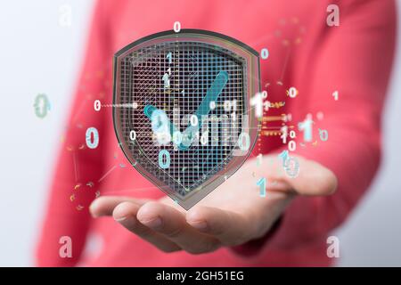 A concept of cybersecurity and information or network protection, 3d shield floating on the hand Stock Photo