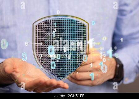 A concept of cybersecurity and information or network protection, 3d shield floating on the hand Stock Photo