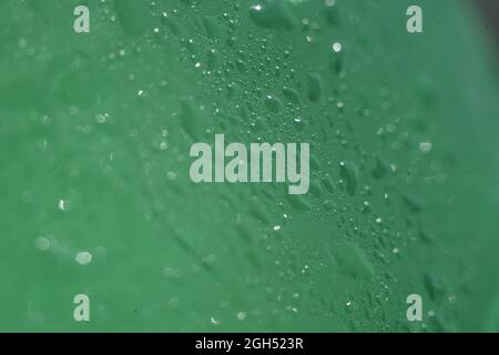 water drops on a green bottle with selective focus Stock Photo