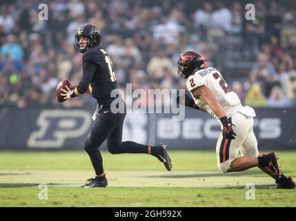 West Lafayette, Indiana, USA. 04th Sep, 2021. Purdue quarterback Jack Plummer (13) passes the ball as Oregon State linebacker Andrzej Hughes-Murray (2) pursues during NCAA football game action between the Oregon State Beavers and the Purdue Boilermakers at Ross-Ade Stadium in West Lafayette, Indiana. Purdue defeated Oregon State 30-21. John Mersits/CSM/Alamy Live News Stock Photo