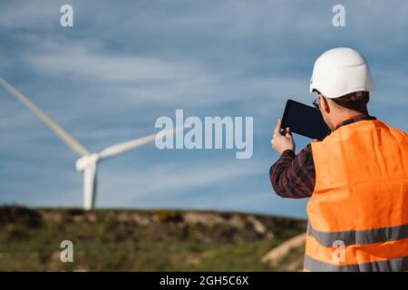 Engineer working at alternative renewable wind energy farm - Sustainable energy industry concept Stock Photo