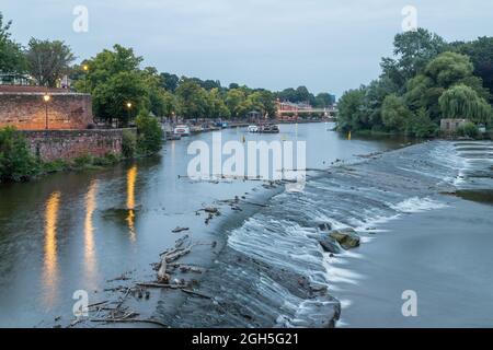 A high dynamic range image of water on the River Dee flowing over the Weir at Chester seen one evening in September 2021. Stock Photo