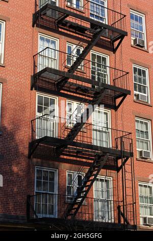 New York, USA - November 22, 2010: Old residential buildings in Soho district. Fire escape stairs. Stock Photo