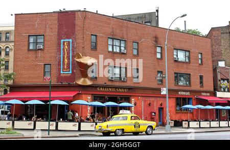 New York, USA - August 3, 2014: 1950 Studebaker yellow taxi outside the Caliente Cab restaurant on Seventh Avenue South in Greenwich Village in New Yo Stock Photo