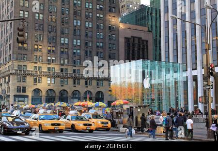 New York, USA - November 21, 2010: Apple Store cube and yellow cabs on 5th Avenue in New York City. Stock Photo