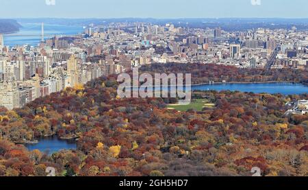 Fall colors of Central Park foliage in late afternoon. Aerial view toward Central Park West. Upper West Side, Manhattan, New York City Stock Photo