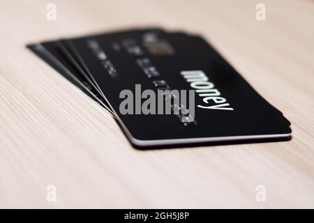 Credit card in black with the inscription money on a wooden table Stock Photo