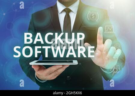 Text caption presenting Backup Software. Business approach create extra exact copies of files or entire computers Man In Office Uniform Standing Stock Photo