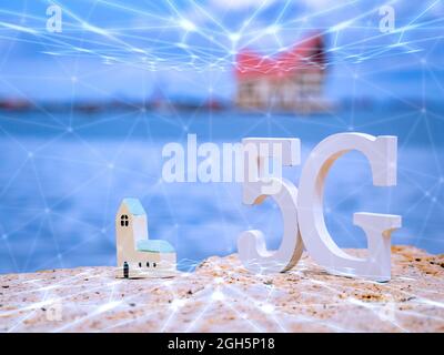 Symbol of white 5G with wifi and transmission network on stone seaside with blue sky. Network internet, communication wireless and 5G standard of sign Stock Photo
