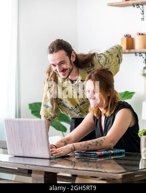 Male and female creative designers drawing sketches on graphic tablets while working together on project in workspace Stock Photo