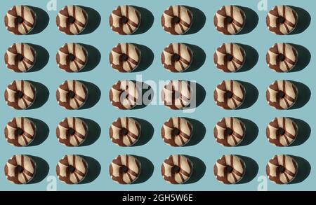 Top view of many donuts covered with chocolate black and white on blue background Stock Photo
