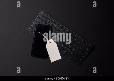 Black friday concept with mobile phone and keyboard on black Stock Photo