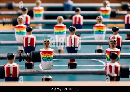 High angle of detail of retro table soccer with wooden miniature figurines of players on metal bars Stock Photo
