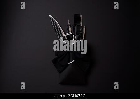 Black Friday concept. A kitchen set of black knifes on black background. Sharp knifes, kitchen slicer and scissors in the shopping bag packaged and Stock Photo