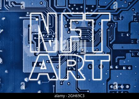NFT art text on blue printed circuit board. Electronic board and NFT technology. Rolling out new NFT technology. Monetizing art with new digital NFT Stock Photo