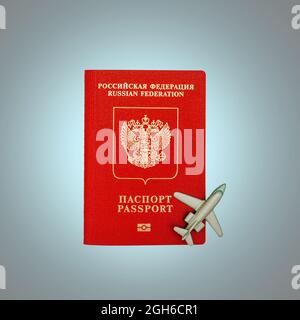 Toy plane and Russian passport. The concept of the beginning of the tourist season and the removal of restrictions on rest. Top view Stock Photo