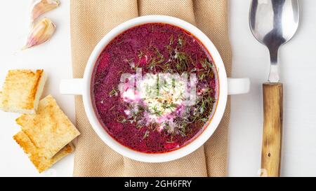 Borsch, Ukrainian traditional beetroot soup made from potatoes, carrots, onions and tomatoes in meat broth, seasoned with sour cream and dill Stock Photo