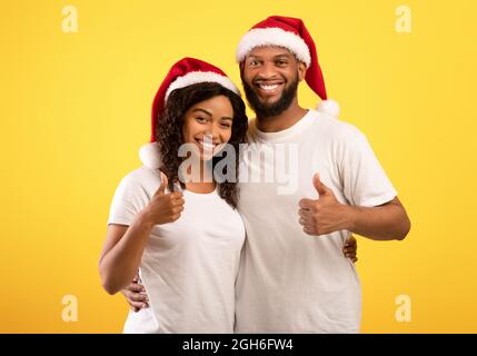 Happy Millennial Lady In Santa Hat And Christmas Sweater Holding