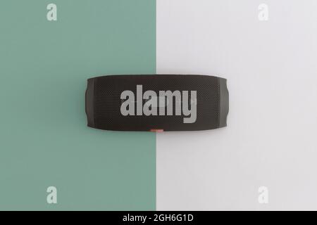 Wireless portable audio speaker for connecting to other device on a color background. Stock Photo