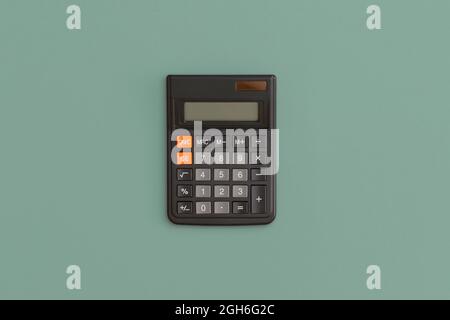 Calculator on green background. Back to school Stock Photo