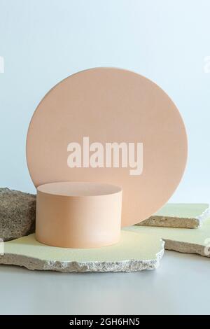 Creative concrete stone and beige platform podium for cosmetics or products on white background. Front view Stock Photo