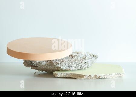 Creative concrete stone and beige round platform podium for cosmetics or products on white background. Front view Stock Photo