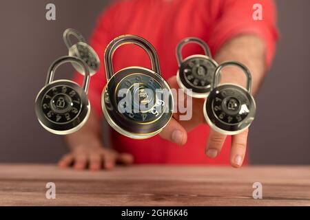 A hand touching floating padlocks - the concept of security Stock Photo